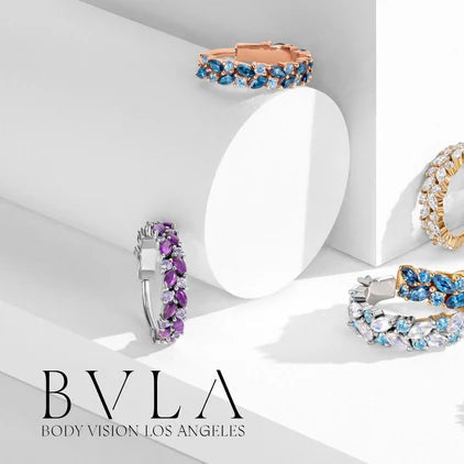 Collection of colorful gemstone rings on a white background with 'BVLA' branding.